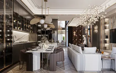 Luxurious Open-Plan Living with Gourmet Kitchen and Dining. A luxurious open-plan living area combining a modern kitchen with dark cabinetry and marble, a stylish dining table, and a plush white sofa, under unique chandeliers.