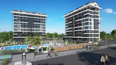 Modern Apartment Complex with Pool and Green Areas. Exterior view of a modern apartment complex featuring two contemporary grey and white buildings. Includes a large outdoor swimming pool, playground, and landscaped green areas with palm trees.