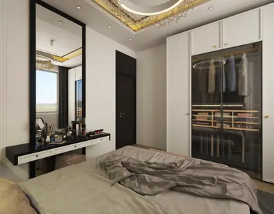 Stylish Modern Bedroom with Built-in Wardrobe and Vanity. A modern bedroom featuring a large bed, a floating vanity with a tall mirror, and a stylish built-in wardrobe with glass doors. Natural light enters from a window, complemented by a decorative ceiling light.
