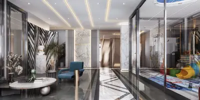 Luxurious Modern Lobby with Integrated Kids Play Area. A luxurious, modern building lobby featuring glossy marble floors with geometric patterns, contemporary blue seating, and sleek integrated lighting. A glass wall reveals an adjacent children's play area.
