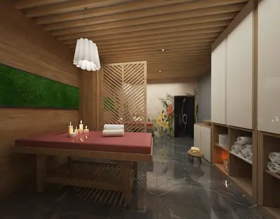 Luxurious Spa Massage Room for Ultimate Relaxation and Wellness. A modern, luxurious spa room featuring a massage table with lit candles and towels. It boasts dark marble flooring, wooden slatted walls, and built-in towel storage, creating a serene wellness experience.