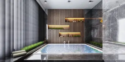 Luxury Indoor Pool Area with Modern Design and Wood Accents. A luxurious indoor pool or spa area featuring a sleek rectangular pool. Modern design with dark marble, slatted wood accent wall with illuminated shelving, and green decorative plants. Overhead track lighting provides ambient illumination.