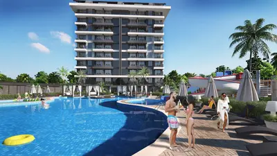 Modern Apartment Building with Resort-Style Swimming Pool. An expansive, modern outdoor swimming pool area in a luxury residential complex, featuring a large blue tiled pool, sun loungers, cabanas, and a water slide.