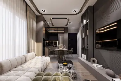 Luxury Modern Open-Plan Living Area with Integrated Kitchen. A luxurious, modern open-plan living room, dining, and kitchen. Features a large sofa, marble coffee table, sleek dark kitchen, integrated appliances, and stylish TV unit. Recently renovated.