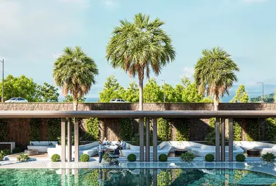 Luxury Poolside Social Area with Palm Trees and Lounge Seating. A modern outdoor common area showcasing a pristine swimming pool. A shaded lounge with stylish white seating, lush greenery, and tropical palm trees offers a luxurious relaxation zone.
