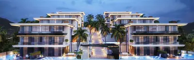 Luxury Modern Victoria Villas with Illuminated Pools at Dusk. Exterior view of Victoria Villas, a modern luxury residential complex with multi-story buildings, infinity pools, and palm trees, illuminated at dusk against a mountainous backdrop.