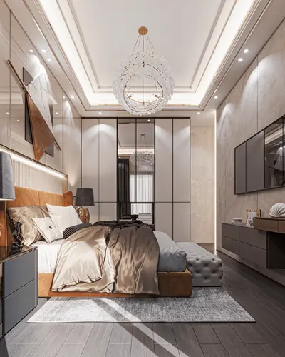 Luxurious Modern Bedroom with Elegant Chandelier and Wardrobes. A luxurious modern bedroom featuring a large bed with satin bedding, dark wood flooring, and a crystal chandelier. Built-in wardrobes and a wall-mounted TV complete the elegant space.