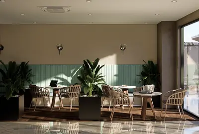 Modern Social Lounge with Greenery and Natural Light. A modern social area with woven chairs, small tables, a mint green banquette, and beige slatted wall. Potted plants and natural light fill the inviting space, featuring wood and marble flooring.