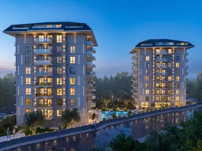 Modern Residential Buildings with Pool and Landscaped Gardens. Exterior view of a modern residential complex at dusk, featuring two multi-story apartment buildings with illuminated windows, balconies, and a vibrant swimming pool area surrounded by lush landscaping.