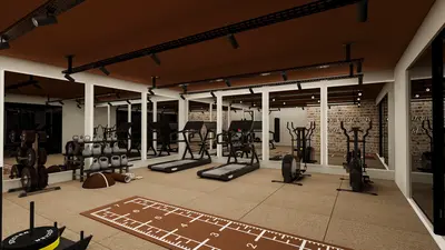Modern Fitness Center with Extensive Gym Equipment. A well-equipped modern fitness center featuring treadmills, elliptical machines, and free weights. The space has light brown flooring, track lighting, and mirrored walls creating an expansive feel.