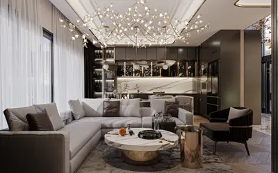 Luxurious Open-Plan Living Room with Modern Integrated Kitchen. Luxurious open-plan living room featuring a large L-shaped sofa, marble coffee table, and an ornate chandelier. A modern integrated kitchen with dark cabinetry and marble backsplash completes this elegant space.