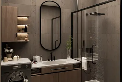 Modern Bathroom with Shower, Vanity, and Laundry Appliance. A modern, renovated bathroom featuring dark tiled walls, black fixtures, an oval mirror, and a spacious walk-in shower. It includes a stylish vanity with sink and an integrated washing machine.
