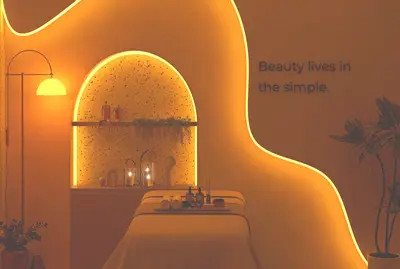 Serene Spa Treatment Room with Ambient Lighting. A serene and modern spa treatment room featuring a massage bed, warm orange ambient lighting, and decorative wall niche. Spa products and rolled towels are neatly arranged, creating a relaxing atmosphere.
