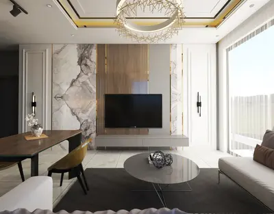 Modern Luxury Living Room with Elegant Marble Accents. A bright, modern living room showcasing a luxurious marble accent wall, wall-mounted TV, and elegant chandelier. Light tile flooring and large windows create a spacious, inviting ambiance.