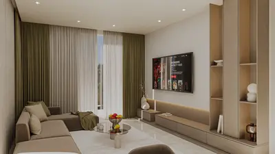 Spacious Modern Living Room with Large TV and Built-in Shelves. Modern living room featuring a spacious sectional sofa, large wall-mounted TV, and built-in media console with shelving. Well-lit by recessed lights and natural light from large windows.