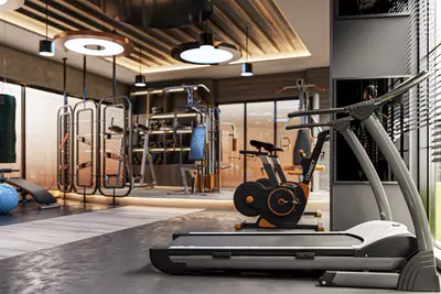 Modern Residential Gym with State-of-the-Art Equipment. A modern, well-equipped residential gym with concrete flooring, showcasing a treadmill, stationary bikes, and various weight machines under warm ambient lighting. Features a punching bag and large windows.