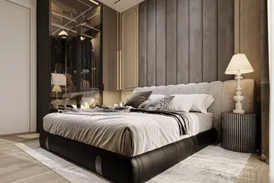 Luxurious Modern Bedroom with Integrated Wardrobe. A luxurious modern bedroom with a king-size bed and a grey upholstered headboard. Features include sleek wooden flooring, a contemporary bedside lamp, and a sophisticated glass-front walk-in closet.