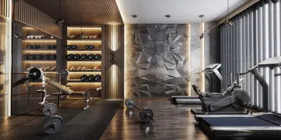 Modern Home Gym with Weights and Cardio Equipment. A modern, well-equipped private gym featuring dark wood flooring and a textured accent wall. It includes weight racks, a bench press, treadmills, and an elliptical for comprehensive workouts.