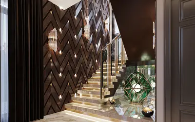 Luxurious Entrance Hall with Modern Marble Staircase. Modern, luxurious entrance hall with a grand marble staircase featuring under-step lighting and sleek railings. A decorative chevron wood wall and elegant green lanterns enhance the sophisticated design.