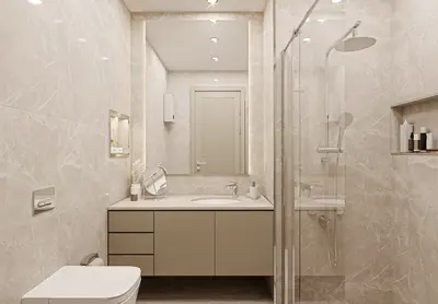 Contemporary Tiled Bathroom with Rainfall Shower and Vanity. Modern renovated bathroom with light marble-look tiles, featuring a glass shower, rainfall head, floating vanity with integrated sink, and illuminated mirror. Recessed lighting.
