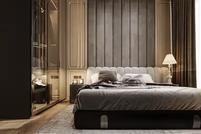 Luxury Modern Master Bedroom with Integrated Wardrobe. A modern master bedroom with a large bed, stylish grey upholstered headboard, and dark wood floors with an area rug. Features include an integrated glass wardrobe and elegant bedside lighting.
