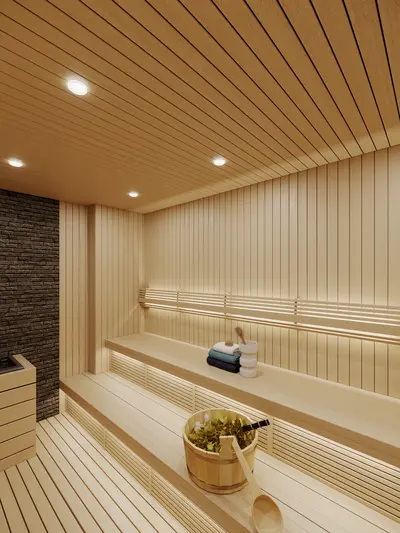 Modern Luxury Sauna Room with Wood Paneling and Indirect Lighting. Modern, clean sauna room with light wooden paneling on walls, ceiling, and tiered benches. Features soft indirect lighting, a stone accent wall, and traditional sauna accessories.