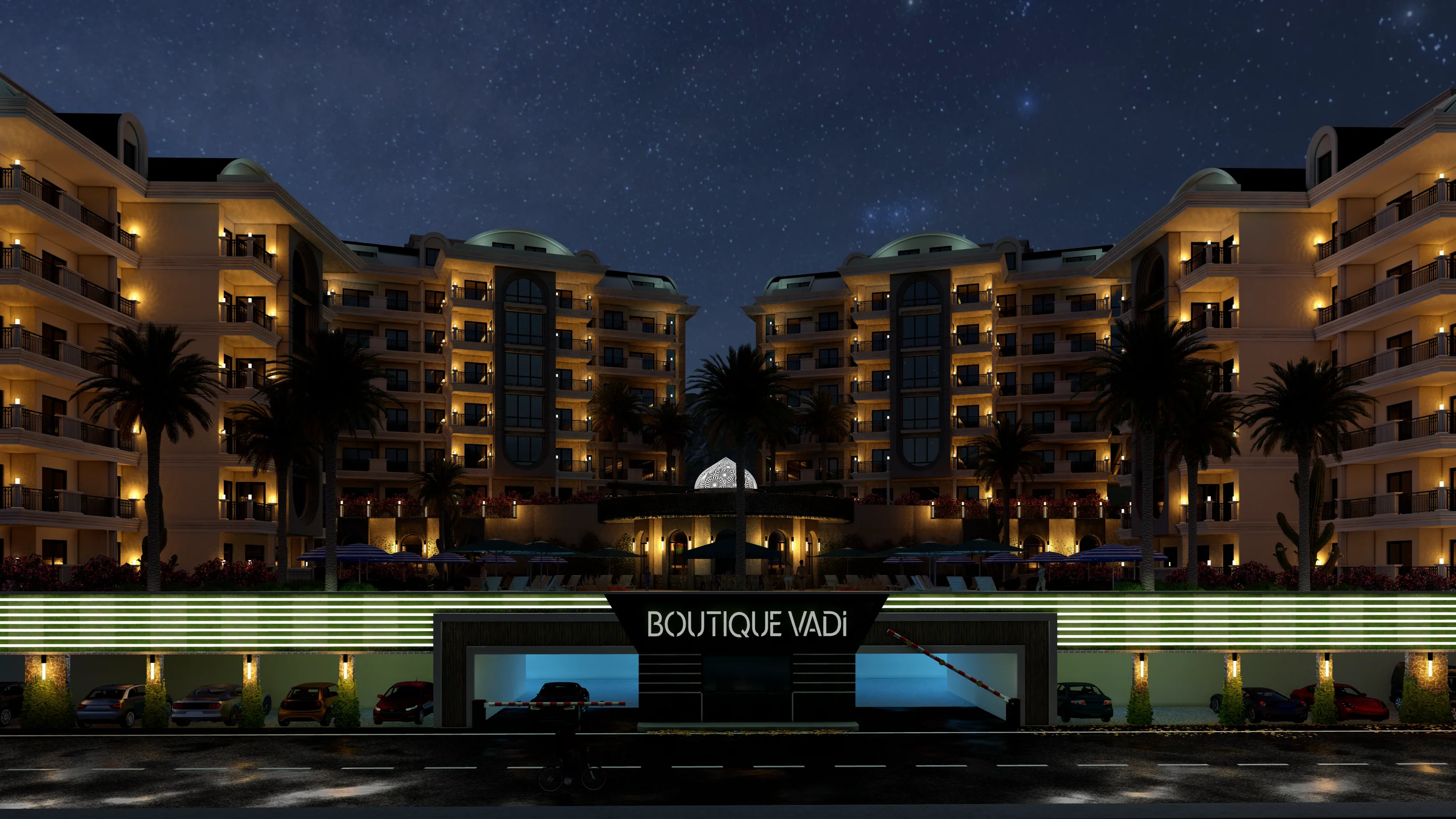 Boutique Vadi Complex Exterior at Night with Underground Parking. Night exterior of Boutique Vadi, a modern luxury residential complex. Features illuminated multi-story buildings, palm trees, and an underground parking garage entrance under a clear, starry sky.