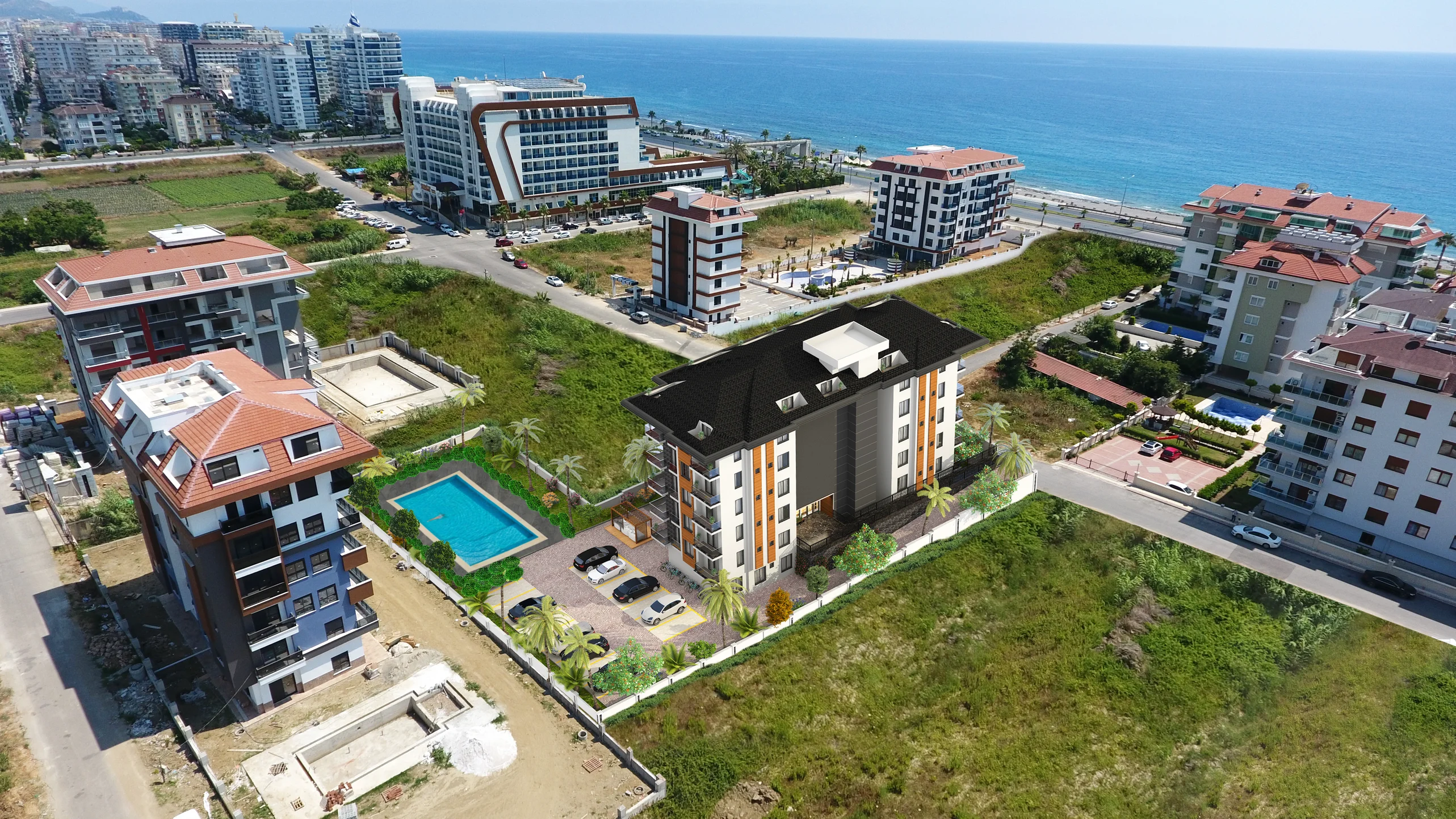 Aerial View Coastal Apartment Development with Pool and Sea View. An aerial drone view showcasing a modern apartment building with an outdoor swimming pool, parking, and green landscaping, set against a backdrop of the sea and other coastal developments.